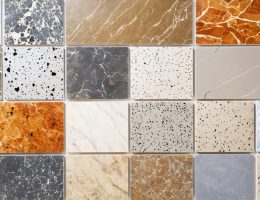 A collage displaying a diverse range of artificial stone textures and colors, featuring surfaces like countertops, flooring, and wall cladding that highlight the material's versatility and elegance.