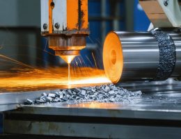 Visual depiction of manufacturing processes showing molten metal pouring into molds, sheet metal rolling, CNC machining, and robotic welding, symbolizing the transformation of raw materials into finished products.
