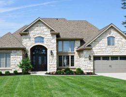 A home's exterior featuring a newly installed DIY stone veneer facade, showcasing both natural and manufactured stone textures and colors, enhancing the property's curb appeal.