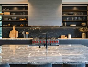 Skilled craftsmen using precision tools to install polished granite countertops in a modern kitchen, showcasing the seamless transformation from raw stone to elegant centerpiece.