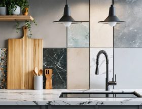 A modern kitchen featuring a variety of affordable countertop materials like laminate, butcher block, recycled glass, and quartz, demonstrating stylish and budget-conscious choices for renovations.
