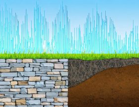 Illustration of a natural stone retaining wall with seismic pressure vectors, depicting the impact of earthquake forces. The background includes a dynamic waveform, symbolizing the seismic activity affecting the wall's stability.