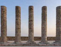 An artistic depiction of seven stone pillars representing cultural heritage and integrity, positioned among architectural elements that bridge ancient and modern preservation practices.