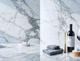 A split image displaying the beauty of a pristine marble countertop on one side, and maintenance tools like a cleaner, cloth, and sealer on the other, symbolizing the elegance and care involved in marble countertop upkeep.