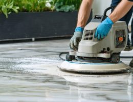"Professional using advanced diamond grinding equipment to transform a worn marble surface into a high-gloss finish, illustrating modern resurfacing techniques and sustainability."
