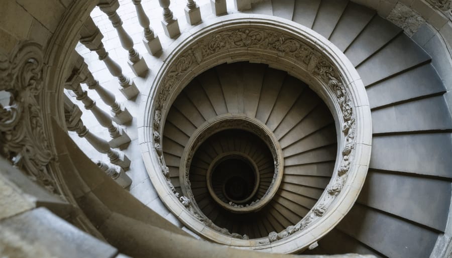 Historic stone spiral staircase with ornate handrail and worn stone steps