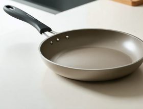 "A ceramic-coated frying pan placed on a modern kitchen countertop, showing its sleek design and smooth surface."