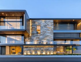 A modern cityscape featuring a LEED-certified building with a natural stone facade, symbolizing sustainable architecture and green building success.