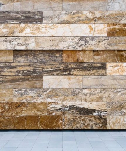 "Facade of a modern building with natural stone panels under soft daylight, set against a blurred urban skyline in the background for a sustainable design focus."