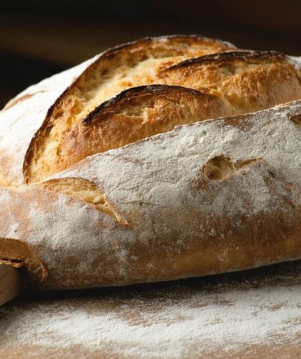 "A professional-grade baking stone with freshly baked artisanal bread, emphasizing the bread's texture and crisp crust in a kitchen setting."