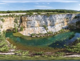 A visually stunning scene of a rehabilitated quarry, showcasing steep rock cliffs with falcons, verdant plant growth, and serene water bodies, reflecting the transformation of an industrial site into a vibrant wildlife sanctuary.