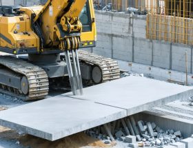 An advanced robotic arm meticulously positioning large stone slabs on a construction site, illustrating the integration of robotics in modern stone installation.