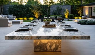 Outdoor setting with a luxurious natural stone table, showcasing marble veining and contemporary dining setup amidst a lush garden environment.