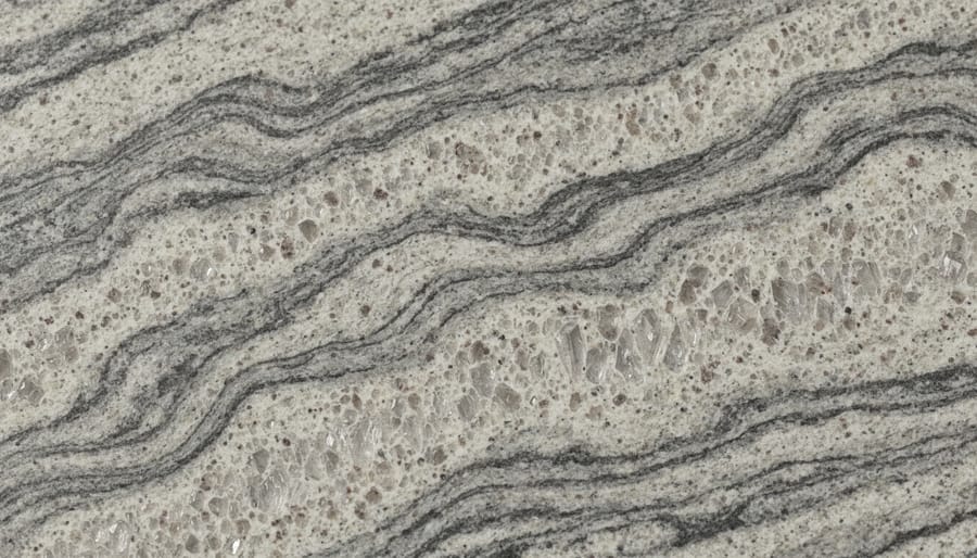 Macro close-up of a polished granite countertop showing natural swirls and speckled grains.