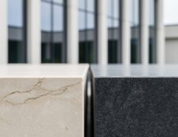 Close-up of limestone and granite slabs used in an architectural span, showing stone veining and texture in soft daylight.