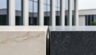 Close-up of limestone and granite slabs used in an architectural span, showing stone veining and texture in soft daylight.