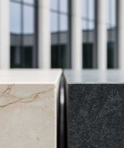 Close-up of limestone and granite slabs used in an architectural span, showing stone veining and texture in soft daylight.