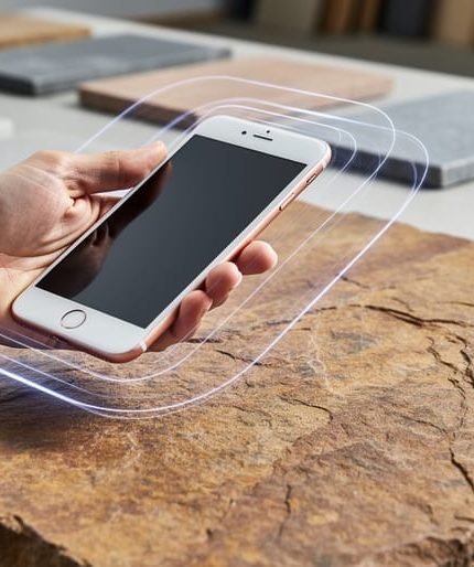 Close-up of a natural stone slab with a hand holding an iPhone above it, suggesting iOS photogrammetry capture for creating a digital 3D model.
